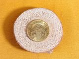 a small coin sitting on top of a piece of cloth