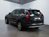 the back end of a blue volvo suv parked in a showroom
