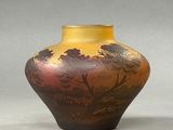 a vase with a painting on it sitting on a table
