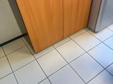 a small kitchen with a refrigerator, microwave, and coffee maker