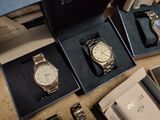 three watches in a box on a table