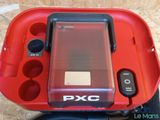 a red box with a phone in it on a table