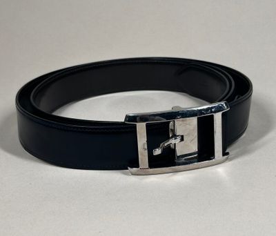 a black belt with a silver buckle on a white surface