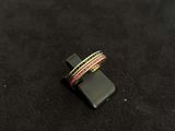 a ring that is sitting on top of a black surface