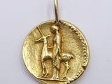 a close up of a gold coin with a man and a dog on it