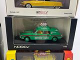 three boxed toy cars in boxes on a white surface