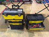 two black and yellow tool boxes sitting next to each other on top of a table