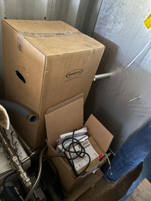 a pile of boxes sitting next to a toilet in a room