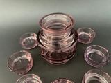 a lot of glass cups and bowls on the table