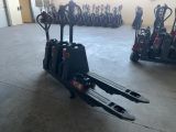 a picture of a forklift in a warehouse with other forklifts in the background