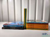 several children ' s books stacked on top of each other on a table