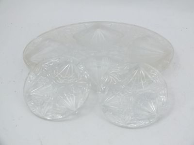 a white plate that has four pieces of plastic on top of it