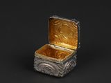 an antique silver and gold box on a black background