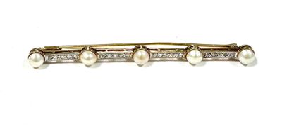 a close up of a brooch with pearls and diamonds