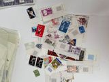 a pile of stamps and postcards on a table