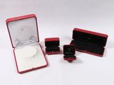 a small red box with a ring inside of it