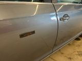 a silver car that has a sticker on the side of it