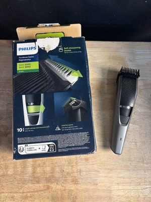 une boîte sur laquelle est représentée une tondeuse à cheveux