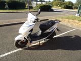 a scooter that is parked in the parking lot