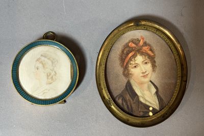 two miniature portraits of a woman and a man are shown in a gold frame