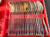 many forks and spoons in a red box