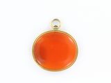 a close up of an orange pendant on a white surface