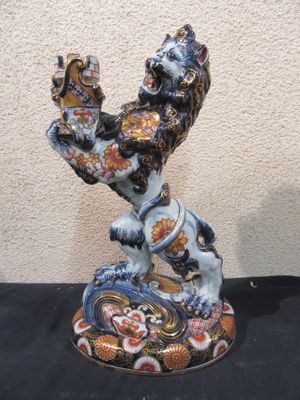 a figurine of a lion on a black table
