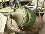 a green vase sitting on top of a table in a room