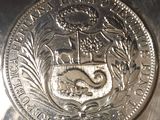 a close up of a silver coin with a coat of arms on it