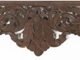 an image of a wooden shelf with a decorative design on it