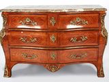 a wooden chest of drawers with a marble top