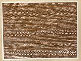 un dessin représentant un motif, en marron et blanc, sur une feuille de papier