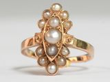 une image représentant une bague en or ornée de perles