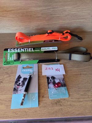 a dog leash, a leash, and a dog tag on a table