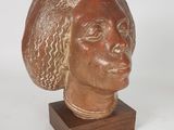 an image of a sculpture of a woman ' s head on a wooden stand