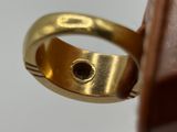 an image of a gold ring with a black diamond