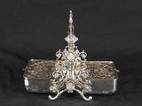 an ornate silver plated box with a handle and handle