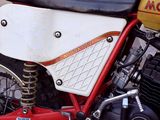 a red and white motorcycle parked on the side of the road