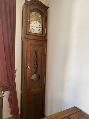 a grandfather clock in the corner of a room