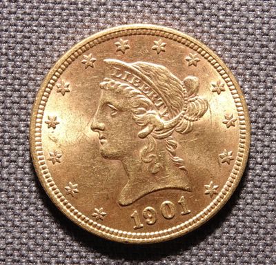 Gros plan sur une pièce d'or ornée d'une tête de femme