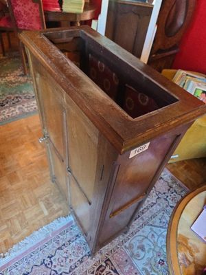 a wooden cabinet with a glass door in the middle of it