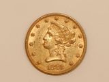 a close up of a gold coin with a woman ' s head on it
