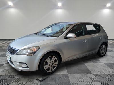 the silver car is parked in the garage on a checkered floor