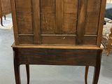an old wooden cabinet with a door on top of it