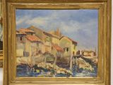 a painting of a village by the water in a gold frame