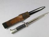 a knife and a sheath on a white surface