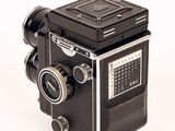 a black and white photo of an old camera