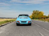 a blue car that is parked on the side of the road