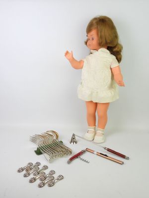 a doll that is standing next to a bunch of tools