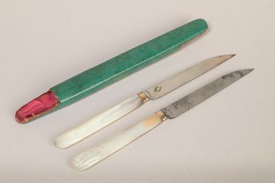three different types of knives on a white surface